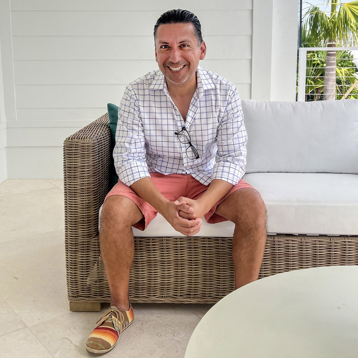 Luis (Lou) Rocco Lozada seated outdoors, smiling at the camera